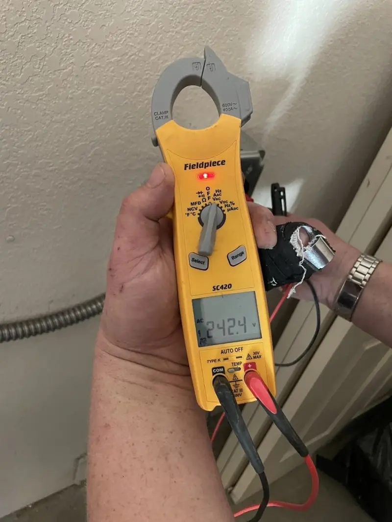 Voltage testing with clamp meter during Recessed Lighting Installation in River Forest
